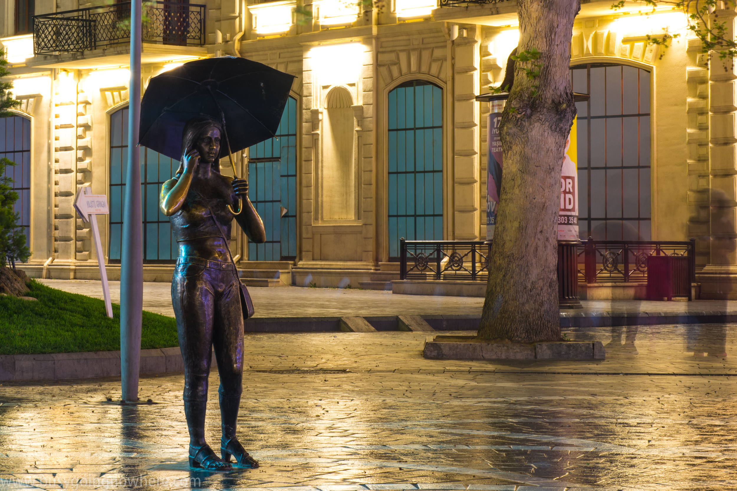 One of many cool statues. Girl with phone and umbrella